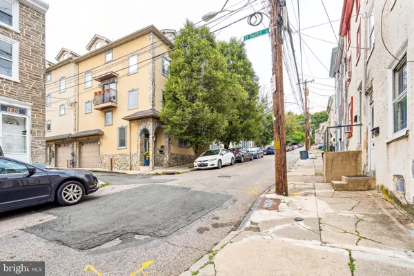 a street view with building and car parked on the road