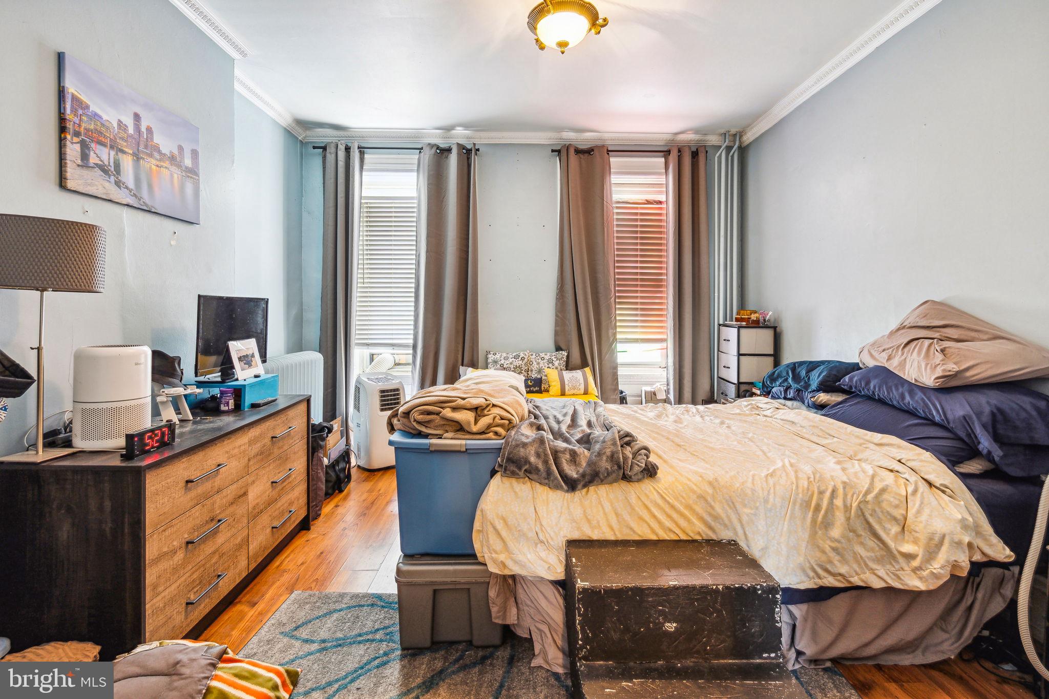 129 Gay Street, Unit 1 Philadelphia, PA 19127 - Photo 7 of 23 a bedroom with a bed and wooden floor