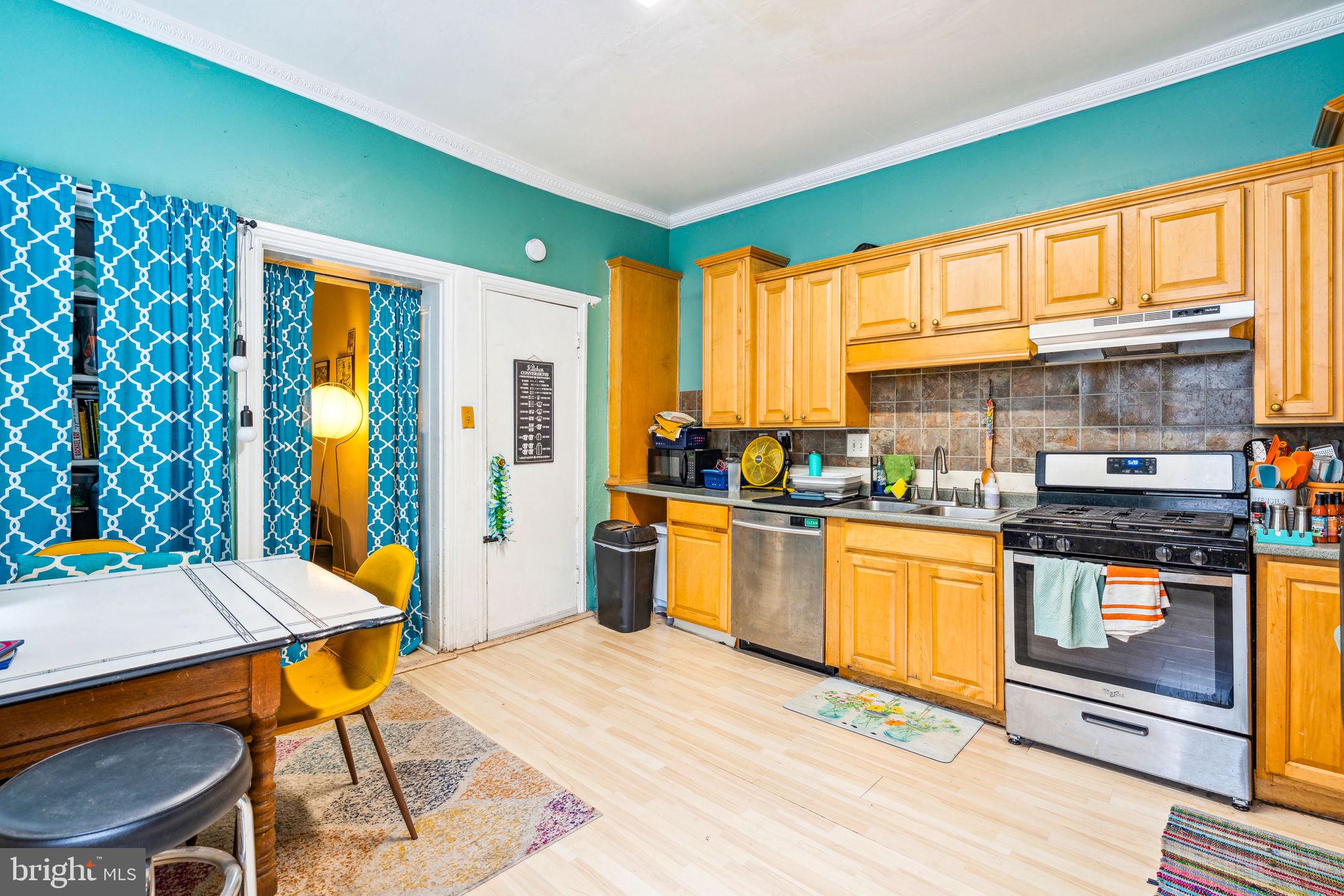 129 Gay Street, Unit 1 Philadelphia, PA 19127 - Photo 9 of 23 a kitchen with stainless steel appliances granite countertop a stove a sink dishwasher and a refrigerator with wooden floor