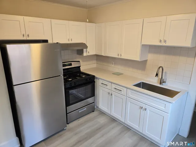 a kitchen with cabinets and stainless steel appliances