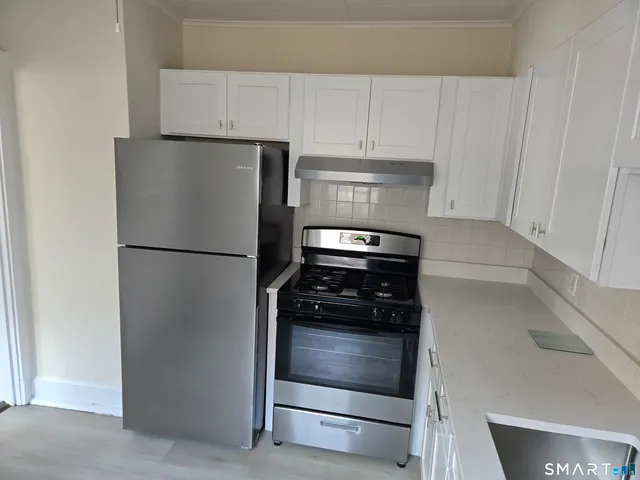 a kitchen with appliances and cabinets