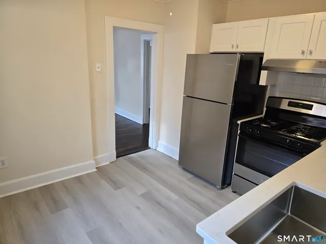 a kitchen with a refrigerator and a stove