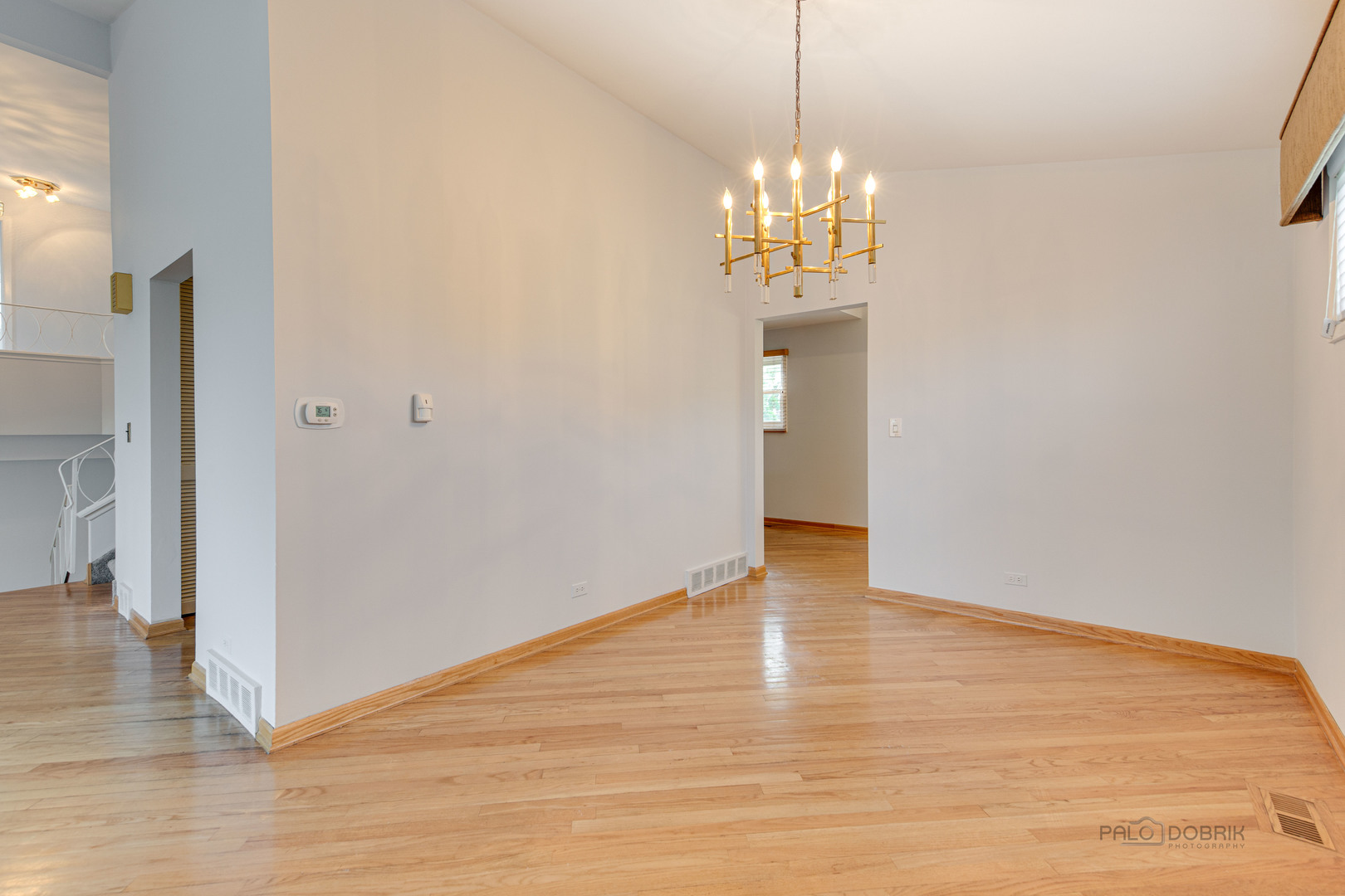 9747 Huber Ovl Niles, IL 60714 - Photo 11 of 38 a view of an empty room with wooden floor and a window