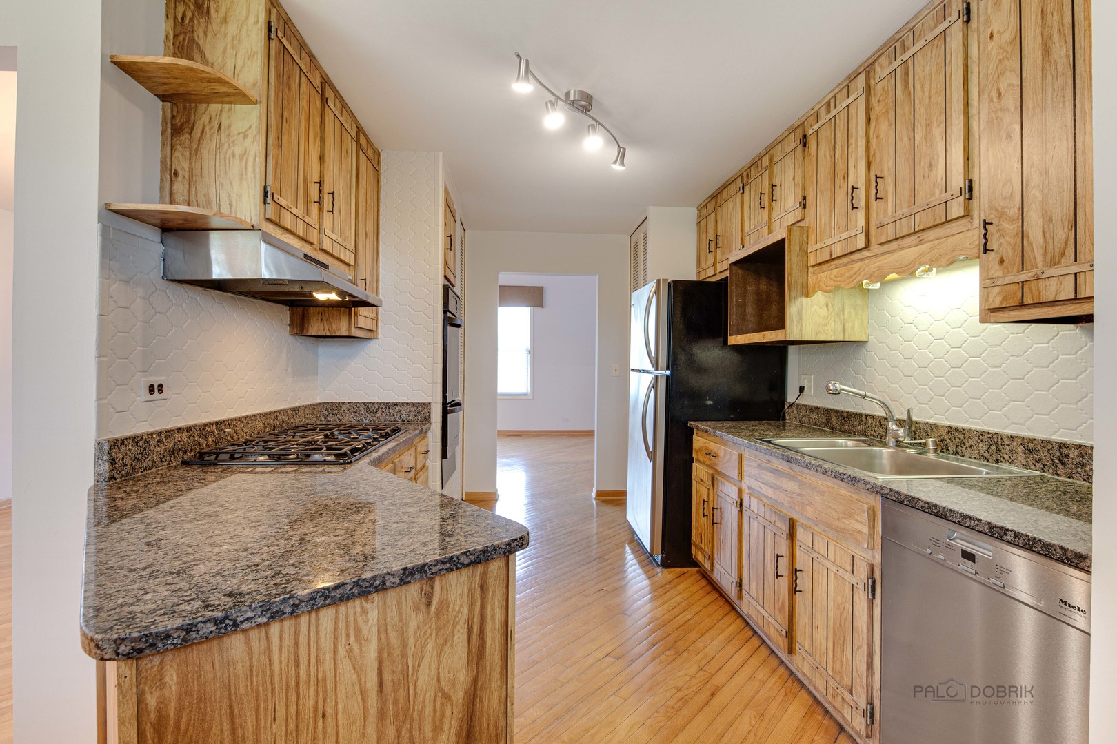 9747 Huber Ovl Niles, IL 60714 - Photo 14 of 38 a kitchen with stainless steel appliances granite countertop a stove a sink and a refrigerator