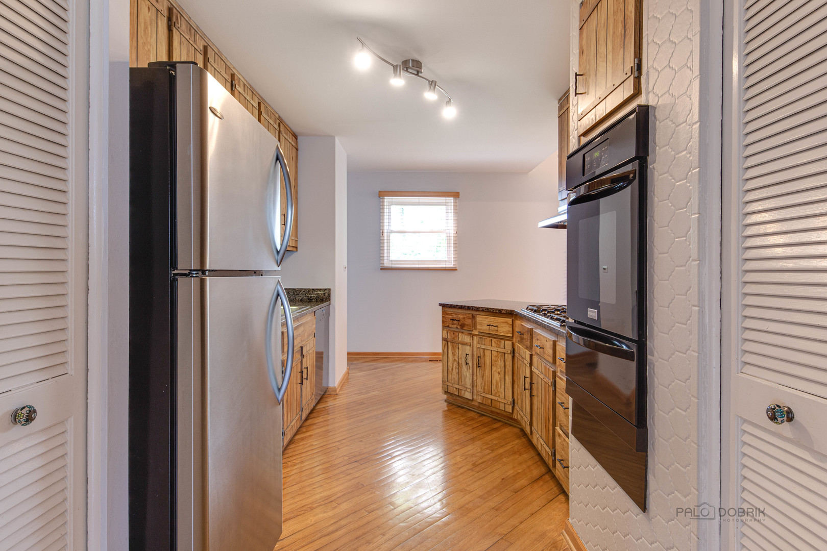 9747 Huber Ovl Niles, IL 60714 - Photo 15 of 38 a hallway with stainless steel appliances granite countertop furniture a refrigerator and a window