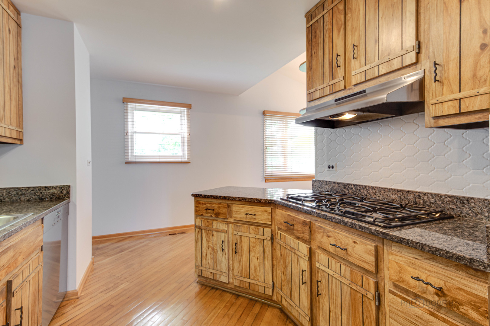 9747 Huber Ovl Niles, IL 60714 - Photo 17 of 38 a kitchen with granite countertop a stove and cabinets