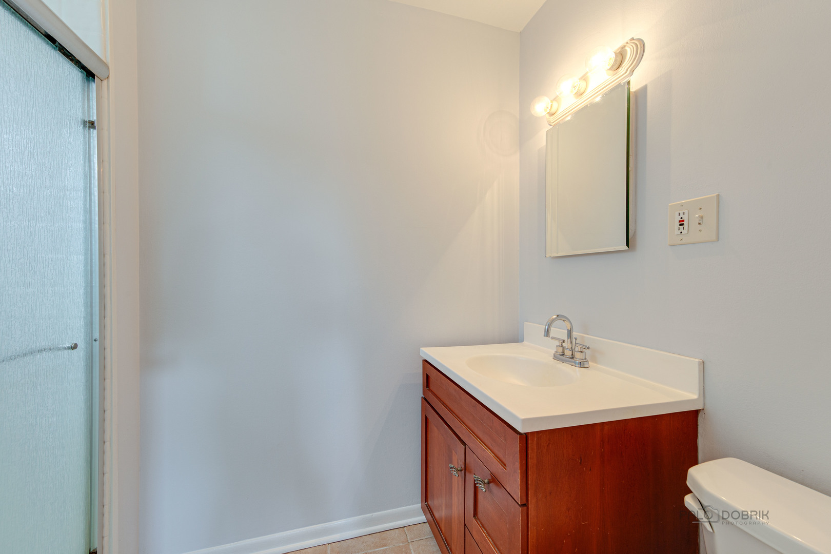 9747 Huber Ovl Niles, IL 60714 - Photo 29 of 38 a bathroom with a sink vanity and mirror