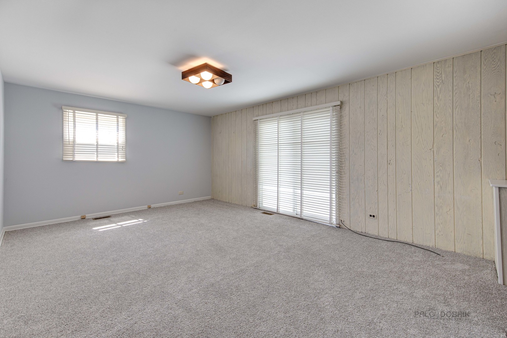 9747 Huber Ovl Niles, IL 60714 - Photo 5 of 38 an empty room with windows and ceiling fan
