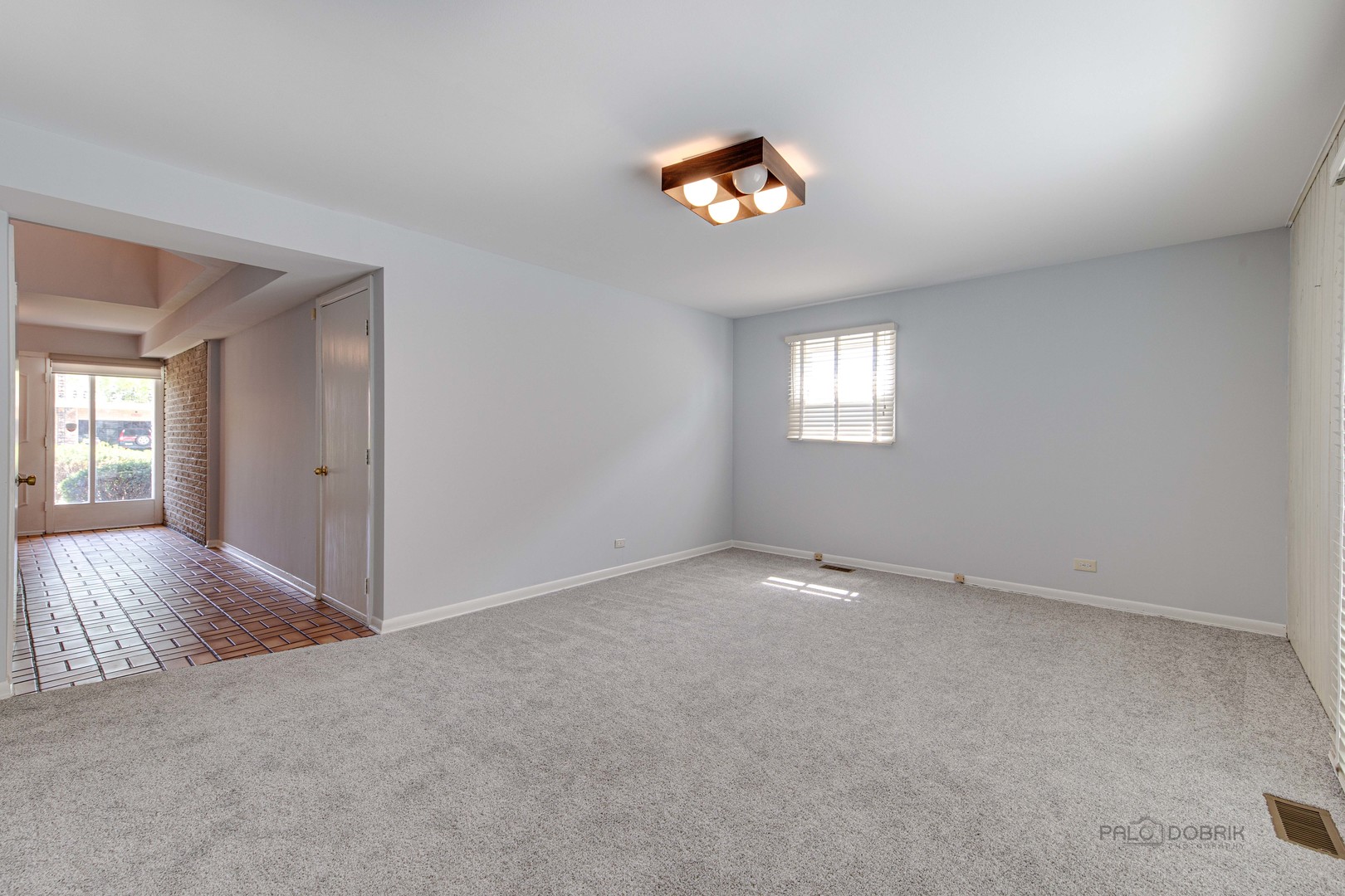 9747 Huber Ovl Niles, IL 60714 - Photo 6 of 38 an empty room with windows and view of kitchen