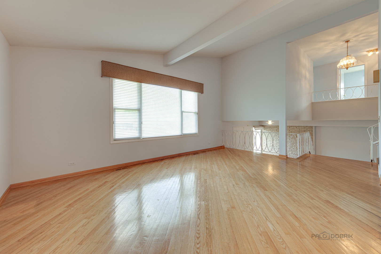 9747 Huber Ovl Niles, IL 60714 - Photo 9 of 38 an empty room with wooden floor and windows