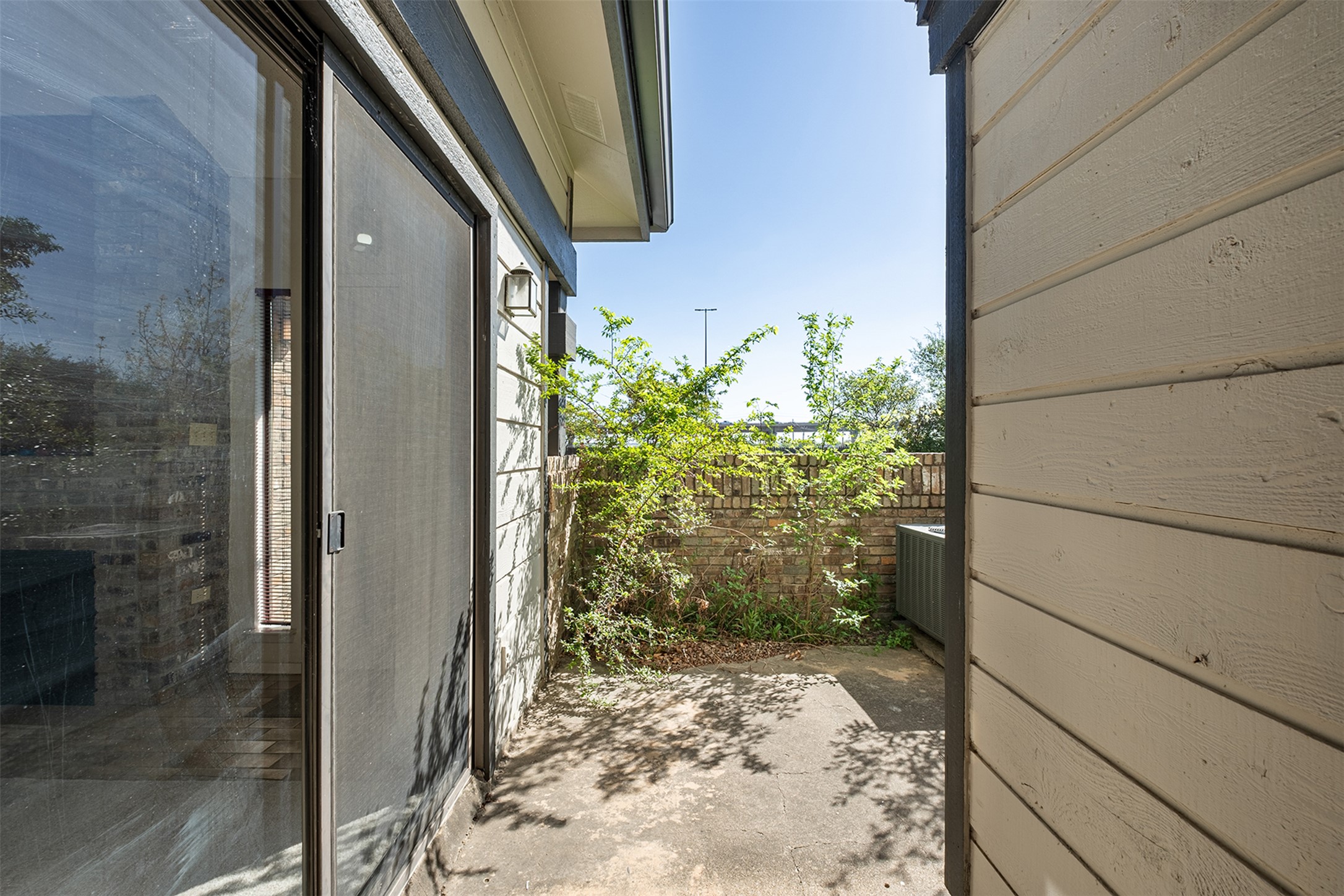 1748 Ohlen Road, Unit 16 Austin, TX 78757 - Photo 31 of 38 View of property exterior with a patio