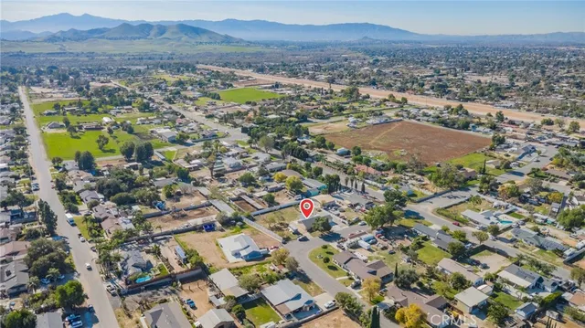 an aerial view of residential house and sandy dunes
