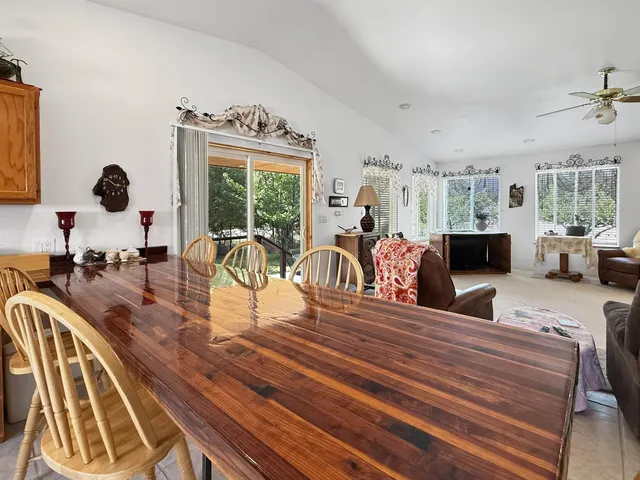 a living room with furniture large window and flat screen tv