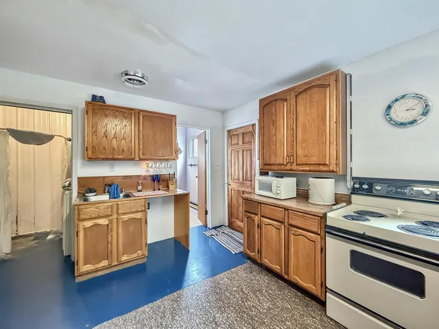 a kitchen with stainless steel appliances granite countertop a stove and a refrigerator