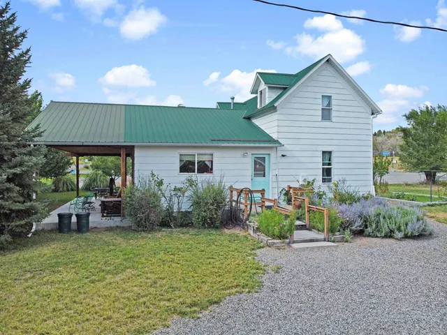a front view of house with yard and outdoor seating