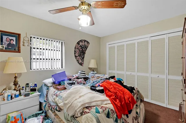 a bedroom with bed and a window