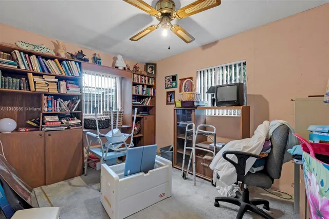 a work room with furniture and a book shelf