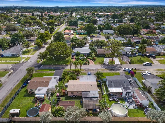 an aerial view of a houses with yard