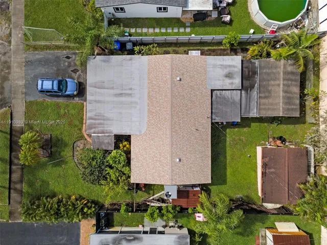 an aerial view of a house with a yard and a fountain