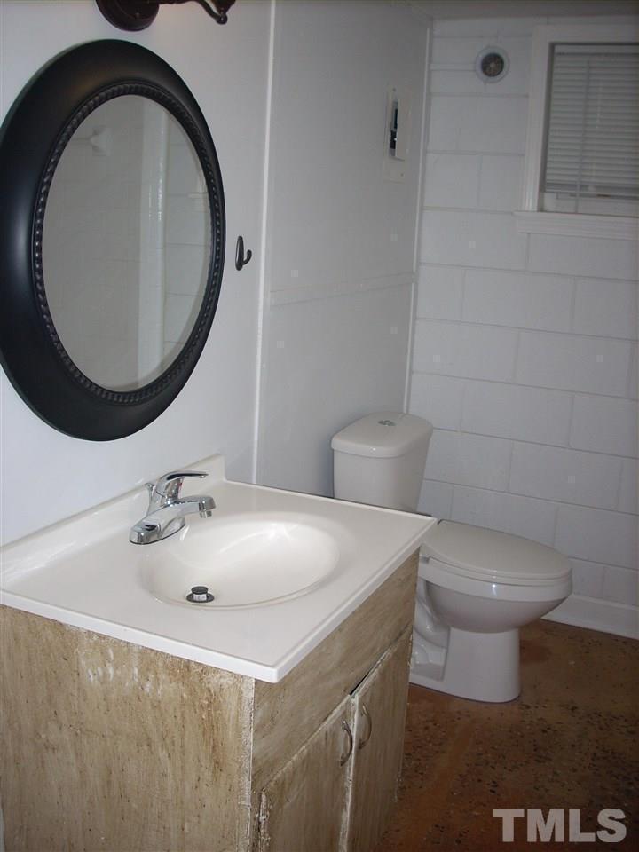 2715 Campbell Road, Unit B Raleigh, NC 27606 - Photo 13 of 25 a bathroom with a sink and a mirror