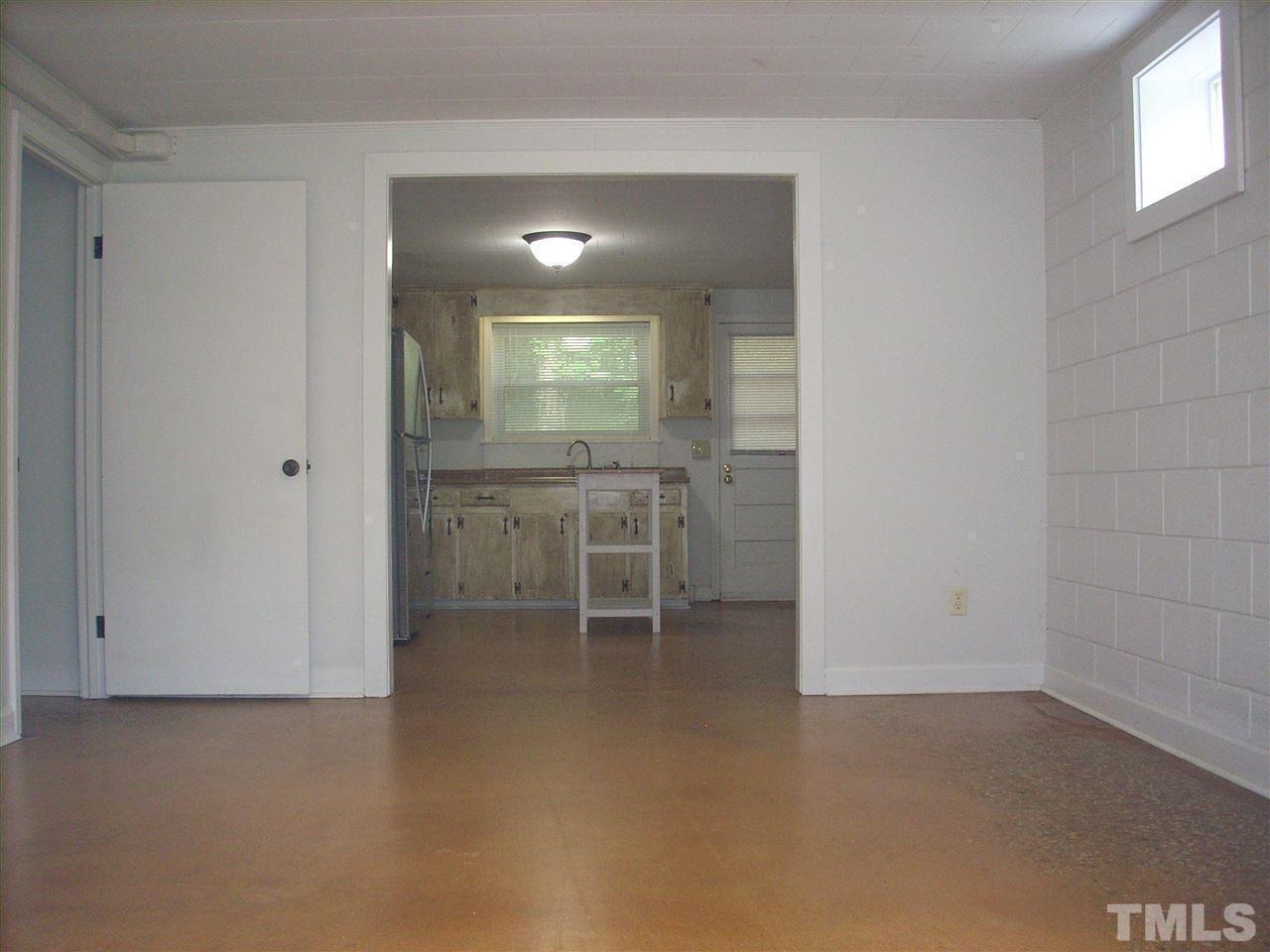 2715 Campbell Road, Unit B Raleigh, NC 27606 - Photo 5 of 25 an empty room with mirror and a sink