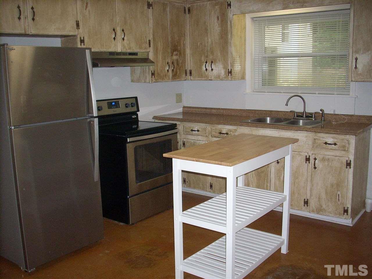 2715 Campbell Road, Unit B Raleigh, NC 27606 - Photo 7 of 25 a kitchen with a sink cabinets and stainless steel appliances