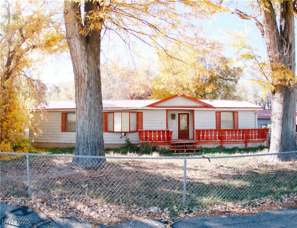31 South 4th Street Panaca, NV 89042 - Photo 2 of 36 Ranch-style home featuring a metal roof and a fenced front yard