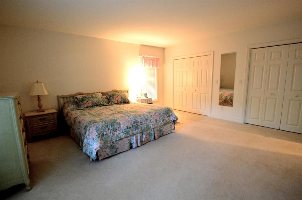 216 Riverview Lane Centerville, MA 02632 - Photo 11 of 16 a spacious bedroom with a bed and a window