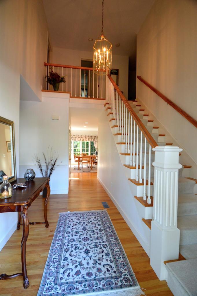 216 Riverview Lane Centerville, MA 02632 - Photo 13 of 16 a view of a hallway with dining room and wooden floor