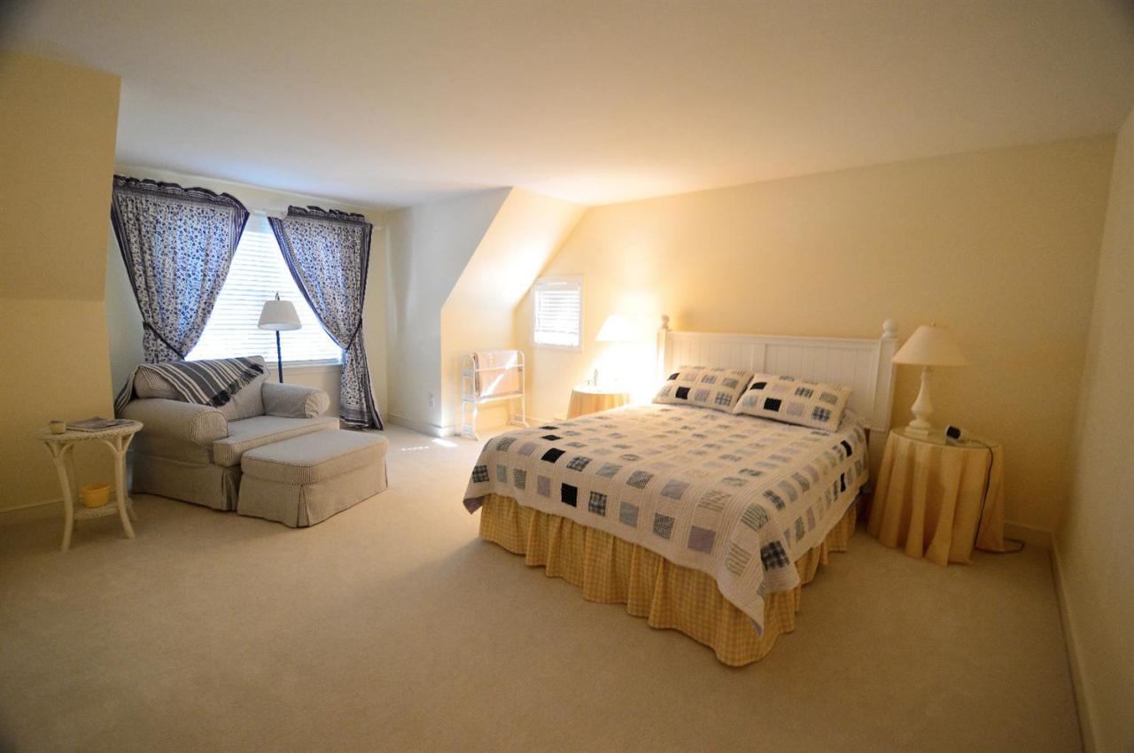 216 Riverview Lane Centerville, MA 02632 - Photo 15 of 16 a spacious bedroom with a bed and a window
