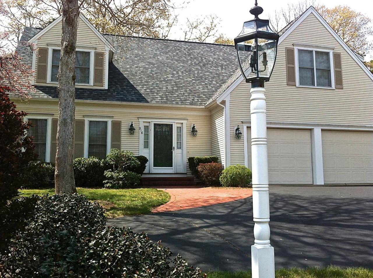 216 Riverview Lane Centerville, MA 02632 - Photo 3 of 16 a front view of a house with garden and porch