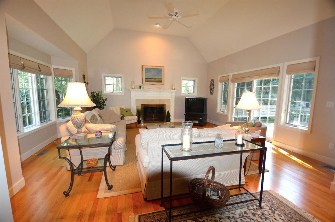 216 Riverview Lane Centerville, MA 02632 - Photo 5 of 16 a living room with furniture a fireplace and a floor to ceiling window