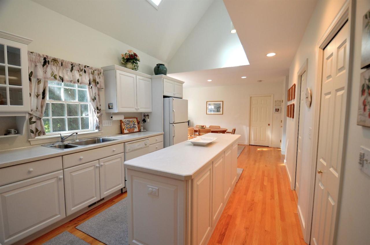 216 Riverview Lane Centerville, MA 02632 - Photo 7 of 16 a large kitchen with a sink and cabinets