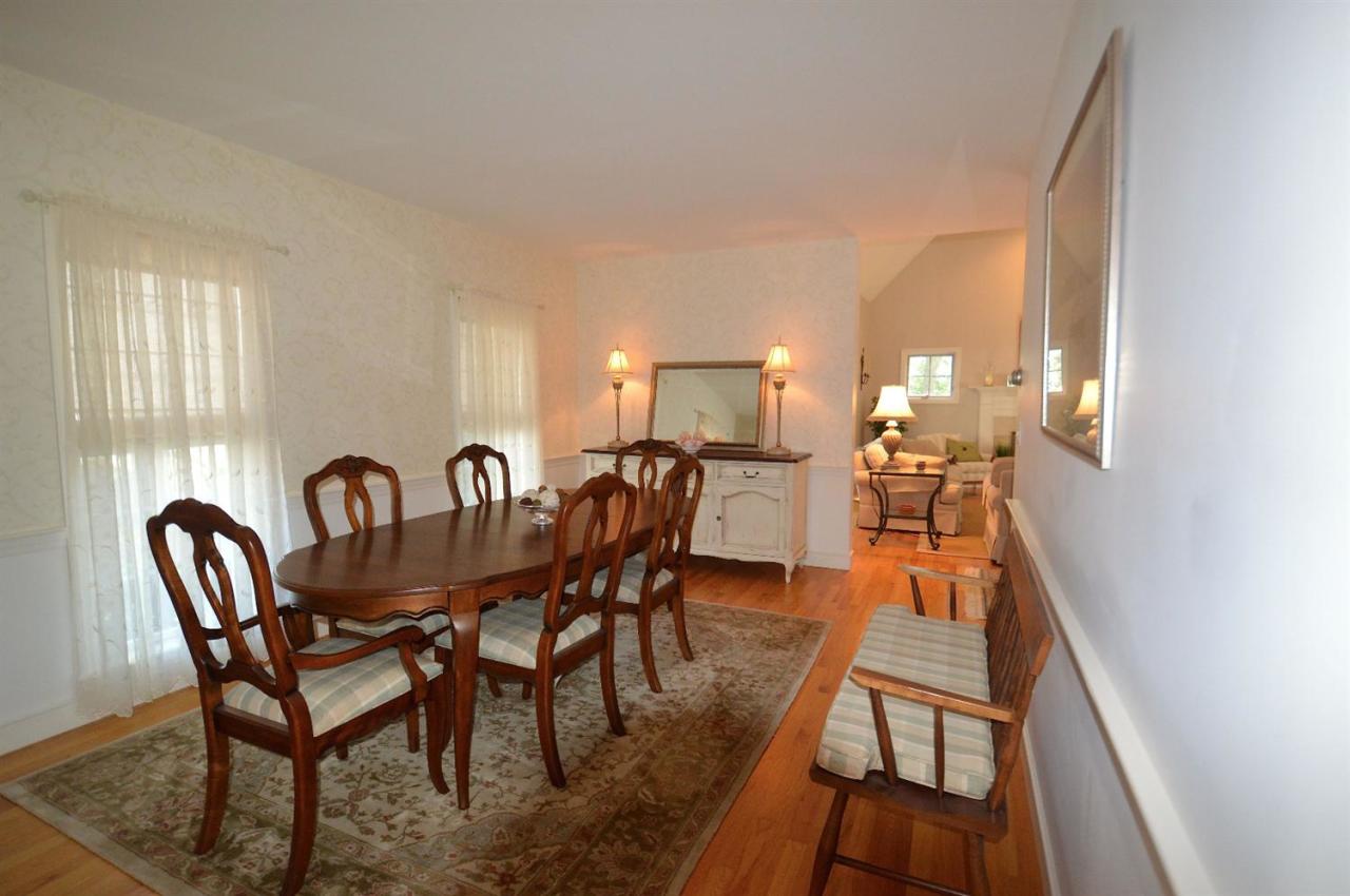216 Riverview Lane Centerville, MA 02632 - Photo 9 of 16 a view of a dining room with furniture and wooden floor