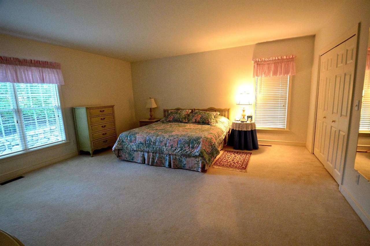 216 Riverview Lane Centerville, MA 02632 - Photo 10 of 16 a bedroom with a bed and wooden floor