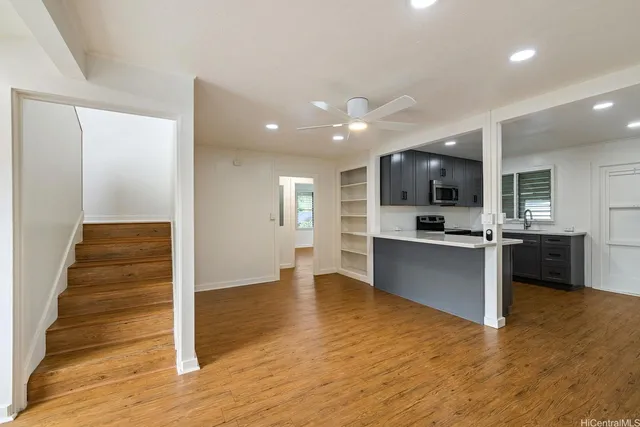 a view of kitchen with sink and refrigerator