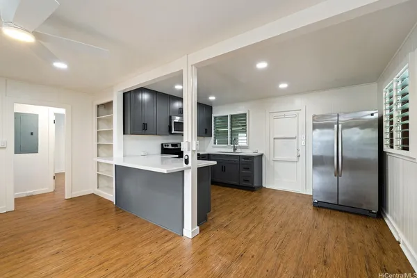 a kitchen with stainless steel appliances a refrigerator and a stove top oven