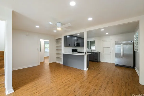 a view of kitchen with refrigerator sink and wooden floor