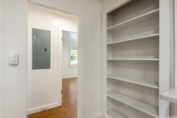 a view of a hallway with wooden floor