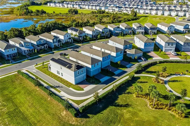 an aerial view of residential houses with outdoor space