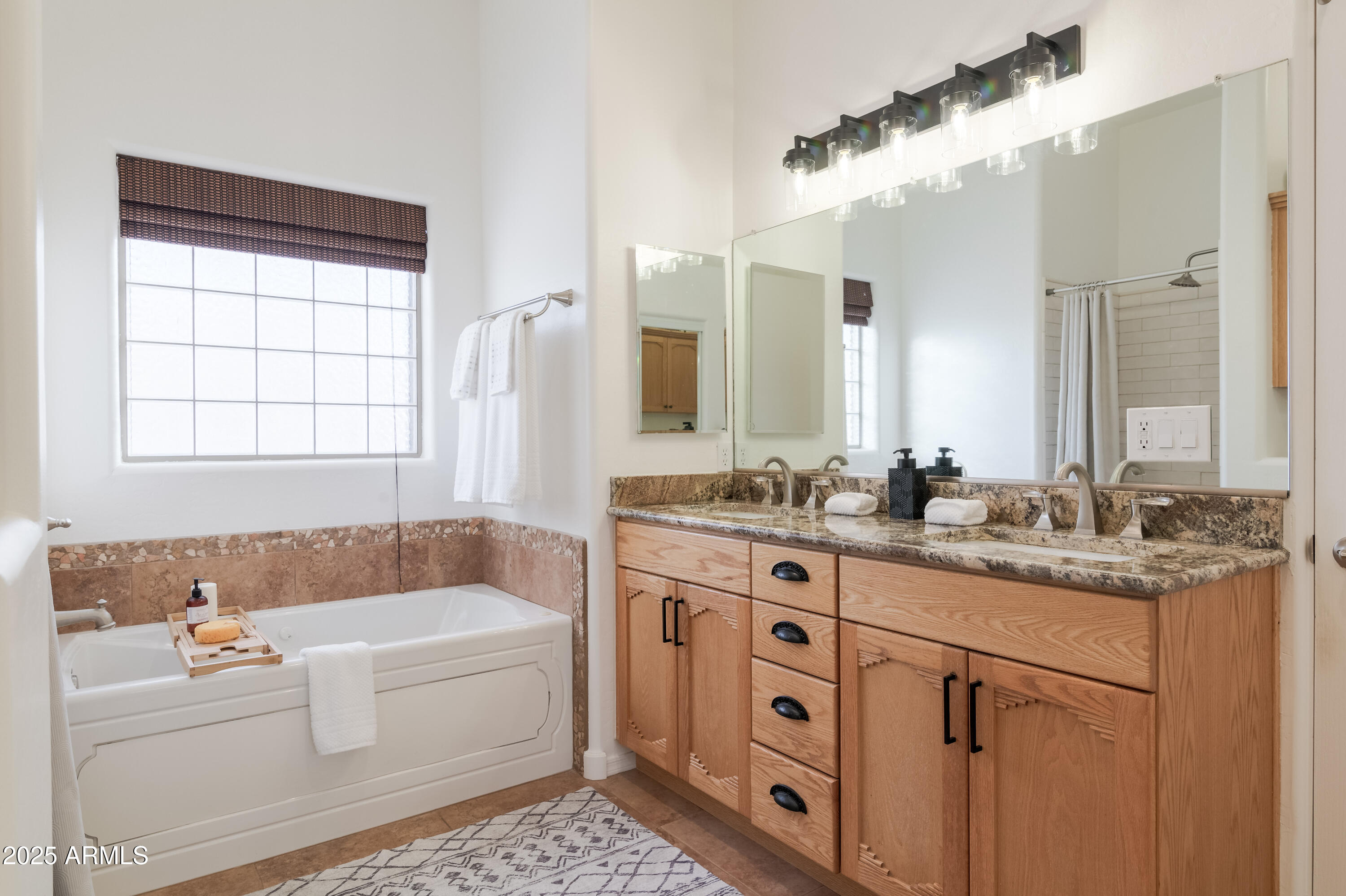 1775 North Starr Road Apache Junction, AZ 85119 - Photo 34 of 48 a bathroom with a granite countertop tub sink and mirror