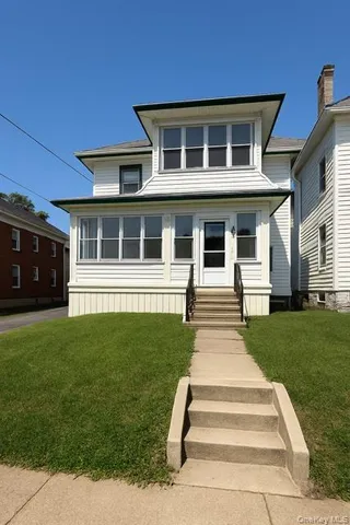 a front view of a house with a yard