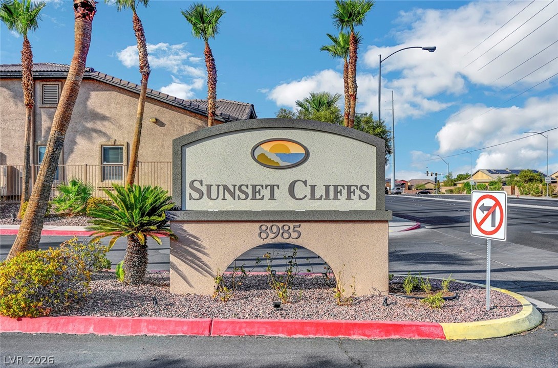 8985 South Durango Drive, Unit 2187 Las Vegas, NV 89113 - Photo 53 of 73 Discover the entrance to a well-maintained community, framed by desert landscaping and vibrant palm trees.