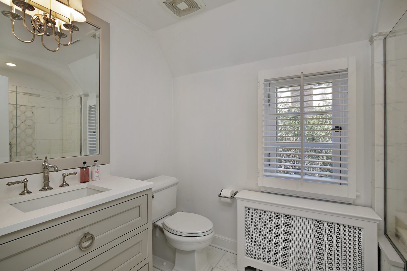 511 Rosemary Road Lake Forest, IL 60045 - Photo 28 of 40 a bathroom with a granite countertop toilet a sink a mirror a window and vanity