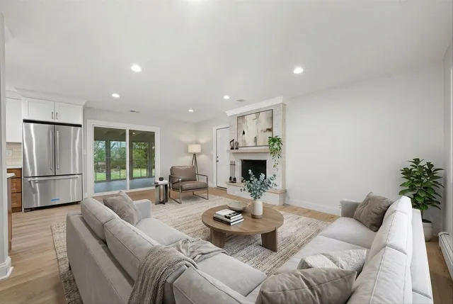 a living room with furniture and a fireplace