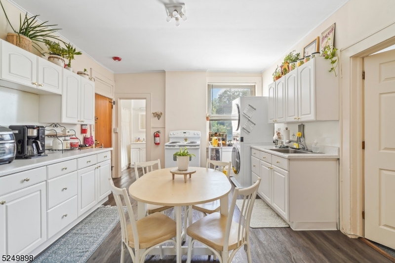 460 Bloomfield Avenue, Unit 3 Caldwell, NJ 07006 - Photo 1 of 8 a kitchen with stainless steel appliances kitchen island granite countertop a table chairs and a refrigerator