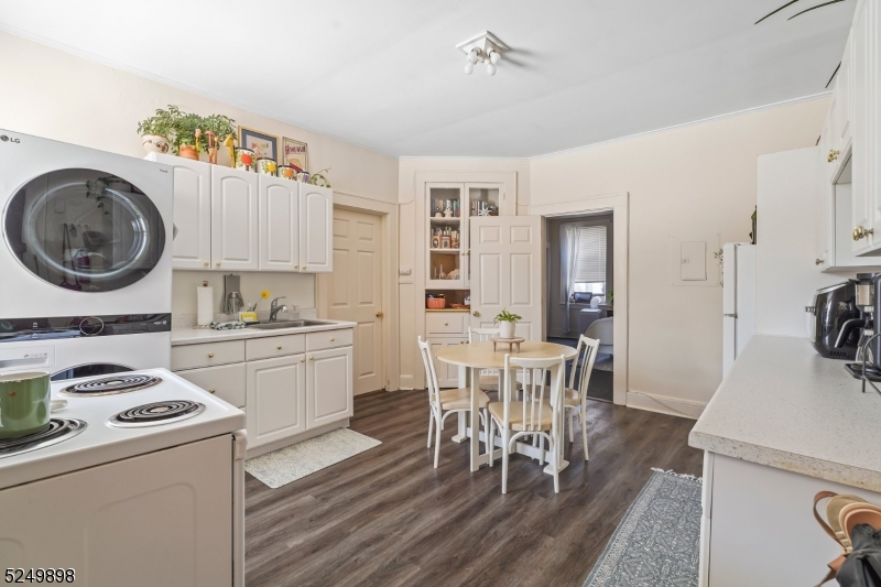 460 Bloomfield Avenue, Unit 3 Caldwell, NJ 07006 - Photo 4 of 8 a kitchen with a dining table chairs and white cabinets