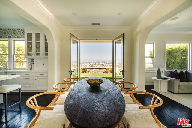 a living room with furniture and a view of kitchen