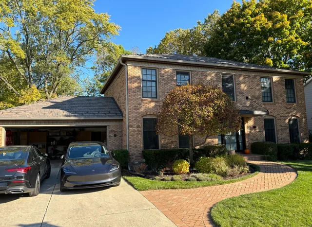 a front view of a house with garden and porch