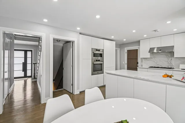 a kitchen with stainless steel appliances granite countertop a sink and a stove